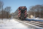 Metra cab car on the move.